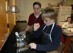 St. Rose of Lima sixth-grader William Roush of Franklin works with science teacher Amber Hayes on a chemistry experiment with new laboratory equipment. Carolyn Kurek said the dedication of the science laboratory was “a very emotional realization that what Joe [Kurek] stood for in his life was something that was going to live on.”