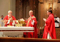 Bishop Kevin C. Rhoades, center, celebrates the Eucharist during the Red Mass at the Cathedral of the Immaculate Conception in Fort Wayne on Sept. 24. Father Mark Gurtner, right, chaplain of the St. Thomas More Society, concelebrated. At left is Deacon Marc Kellams, a special guest at the Red Mass and speaker at the dinner that followed. Deacon Kellams serves St. Charles Borromeo Parish in Bloomington, and is circuit court judge in Monroe County. (Photo by Tim Johnson)