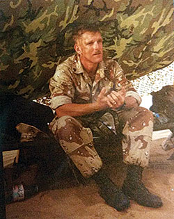 Gulf War veteran Marine Staff Sgt. William Medford sits in a tent during the conflict. It was just before the war began that Medford became Catholic. (Submitted photo)