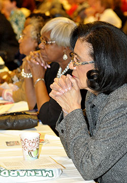 Aster Bekele, a member of St. Rita Parish in Indianapolis, left, Franciscan Sister Jeannette Pruitt, center, and Janice Slaughter, a member of St. Monica Parish in Indianapolis, front, listen during the Indiana Catholic Women’s Conference on March 21 in Indianapolis. (Photo by Natalie Hoefer)