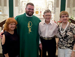 At 103, Tom Horn has always kept moving, except when it comes to his place of worship. He has been a member of St. Augustine Parish in Jeffersonville all his life. He poses in the parish church on Father’s Day of this year with Father Douglas Marcotte, administrator of St. Augustine Parish, and two of his nieces, Sharon Horn, left, and Jerri Brandenburg. (Submitted photo)