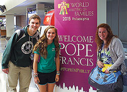 Cathedral High School students Mike Rushka, Rachel Kent and Molly Mitchell pose for a photo in Philadelphia during their recent trip to the World Meeting of Families—an experience that led them to see Pope Francis. (Submitted photo) 