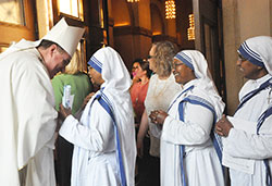 Archbishop Joseph W. Tobin talks with Missionaries of Charity Sister M. Marleen while two other sisters wait their turn to talk with the archbishop in SS. Peter and Paul Cathedral in Indianapolis on Sept. 5 after the Mass of Thanksgiving for the canonization of St. Teresa of Calcutta. (Photo by Natalie Hoefer) 