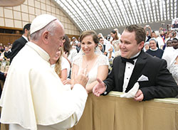 Elisabeth and Scott Williams of St. John the Evangelist Parish in Indianapolis smile in complete joy as they meet Pope Francis at the Vatican on August 3. The couple was married in St. Luke the Evangelist Church in Indianapolis on May 28, and later traveled to Rome after they learned about the long-standing tradition of popes offering a blessing to newlyweds. (Photo courtesy of L’Osservatore Romano) 
