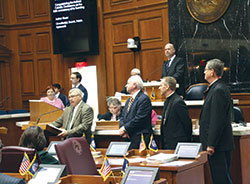 The Indiana General Assembly on Feb. 13 unanimously passed a resolution congratulating the Indiana Catholic Conference (ICC) on the 50th anniversary of its founding. The ICC represents the Catholic Church in Indiana on national and state matters of public policy. Pictured at left reading the resolution is Rep. B. Patrick Bauer (D-South Bend), who authored the bill. To his right are Glenn Tebbe, ICC executive director; Bishop Charles C. Thompson of Evansville; and Bishop Timothy L. Doherty of Lafayette. (Photo by Charles Schisla)