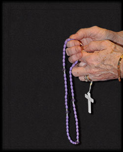 A rosary being prayerfully held. (File photo by Natalie Hoefer)