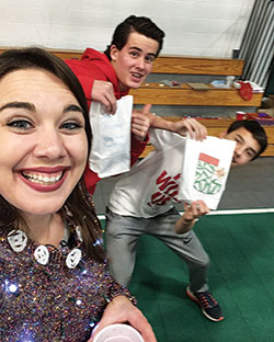 Augusta McGonigal poses in a selfie with Drew Bishop, left, and Michael Aimone, both members of St. Patrick Parish in Terre Haute on Dec. 10, 2017, during a Christmas party for the youth ministry program for the five parishes in Terre Haute. McGonigal is the coordinator of youth ministry for the parishes. (Submitted photo)