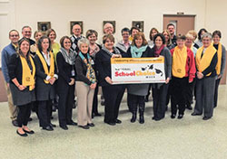 Principals and administrators from the Diocese of Evansville's 26 Catholic schools prouodly display a banner for National Schools Choice Week during their Jan. 15 meeting at the Catholic Center in Evansville. The Message photo by Tim Lilley