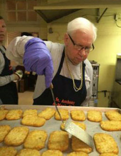 Members of the All Saints Parish A-Men's Club work hard during the 2015 pancake breakfast, including Gene Kempf cooking hash browns. All Saints Parish photo)