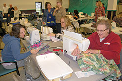 More than 150 volunteers gathered at St. Joan of Arc Parish in Kokomo on Jan. 9 to create colorful hospital-style gowns for hospice patients. It was a “ministry of presence” project for the parish for the Holy Year of Mercy. (Photo by Kevin Cullen)