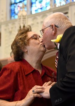 Deacon and Mrs. Robert and Ann Viviano exchange a kiss during the 34th annual wedding anniversary Mass on May 7 at Holy Angels Cathedral in Gary. The Vivianos, who celebrated their 50th anniversary, are members of St. John the Evangelist, where Robert is a senior deacon. (Anthony D. Alonzo photo)