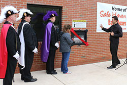 Father Chris Stanish, of Queen of All Saints, blesses a Safe Haven Baby Box during the dedication ceremony April 28. Members of the Knights of Columbus Honor Guard and Monica Kelsey, founder and president of Safe Haven Baby Box, look on as the nation's second baby box was installed and is operational at the Coolspring Volunteeer Fire Department, just south of Michigan City. (Bob Wellinski photo)
