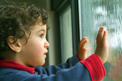 Boy looking out a window
