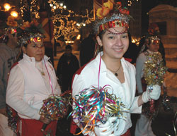 Hispanic teenagers wearing traditional costumes dance at Monument Circle in Indianapolis during an outdoor vigil procession on Dec. 11, 2005, celebrating the feast of Our Lady of Guadalupe on Dec. 12. A large group of Hispanic Catholics of all ages marched to St. Mary Church for a vigil Mass. (Photo by Mary Ann Wyand) 