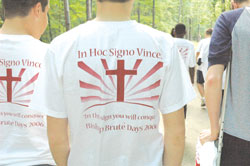 T-shirts worn by participants at Bishop Bruté Days in June show the message that guides people of faith: “In this sign, you will conquer.” The annual retreat helps teenage boys grow in their faith and be open to a possible call to the priesthood. (Photo by Sean Gallagher) 