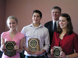 Three students from Cathedral High School in Indianapolis, from left, Katie Zupancic, Michael O’Neil and Elizabeth Jamison, pose with their principal, Dave Worland, during a 2005 luncheon at the Knights of Columbus Hall at 511 E. Thompson Road in Indianapolis. The students were winners in their grade division in the 2005 Indianapolis Serra Club Vocations Essay Contest. (File photo by Sean Gallagher)