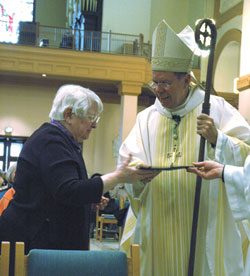 Providence Sister Jane Bodine, who entered religious life in 1937, receives a certificate of appreciation from Archbishop Daniel M. Buechlein during the World Day for Consecrated Life Mass at SS. Peter and Paul Cathedral in Indianapolis.