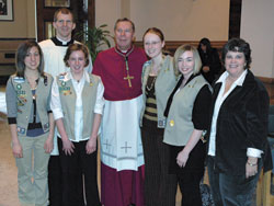 Members of Girl Scout Troop 1602, from left, Kaela Clemons, Kathleen Coyle, Lauren Lucas and Julianna Knight, pose with Mary Lynn Cavanaugh, right, the director of religious education at St. Mark the Evangelist Parish in Indianapolis, Archbishop Daniel M. Buechlein and Father Jonathan Meyer after the Feb. 11 Scout awards ceremony. The troop received the Spirit Alive Award.