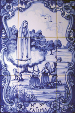 This artwork on ceramic tile depicts Mary appearing to three shepherd children at Fatima, Portugal, in 1917. It is displayed at Our Lady of Fatima Retreat House in Indianapolis.