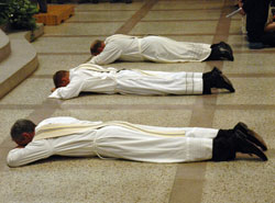 Deacons Kovatch, from left, Nagel and Summers lay prostrate on the floor of SS. Peter and Paul Cathedral shortly before they were ordained to the priesthood.