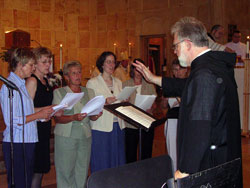 Benedictine Father Jeremy King, a monk of Saint Meinrad Archabbey, leads a multi-parish deanery choir during a June 7 Mass in honor of St. Theodora Guérin at St. Meinrad Church in St. Meinrad. (Photo by Patricia Cornwell) 