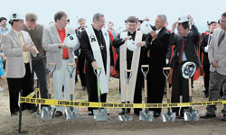 Preparing to break ground for the new St. Malachy Church in Brownsburg on June 24 are, from left, Michael Eagan, lead architect, Entheos Architects; Kevin Stuckwisch, liturgical consultant, Entheos Architects; Richard Judd, building committee chairman; Archbishop Daniel M. Buechlein; Father Daniel Staublin, pastor; Mark Kramer, Pastoral Council chairman; Rob Damler, planning committee chairman; and Paul Toddy, senior project manager, Meyer Najem.