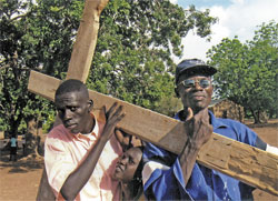 Head catechist Damiasio Ding, left, and Lorenze Makatatu carry the cross during a Lenten procession at St. Theresa Parish in Nyamllel in southern Sudan last year. Lay catechists help Comboni Father Michael Barton, the parish’s pastor, teach the Catholic faith to people in the Diocese of Rumbek. Three Indonesian sisters who are members of the Daughters of Our Lady of the Sacred Heart order and lay teachers help Father Barton at four Comboni schools in Nyamllel. Students study English, Dinka, Swahili, Arabic, science, agriculture, geography, civics, history and religious education. (Submitted photo) 