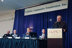 Archbishop Daniel M. Buechlein delivers remarks during the annual meeting of the Catholic Community Foundation on Oct. 24 in Indianapolis. Seated next to the archbishop are, from left, Msgr. Joseph F. Schaedel, archdiocesan vicar general; Toby McClamroch, president of the CCF board of trustees and a member of St. Luke the Evangelist Parish in Indianapolis; Joseph Therber, executive director of the archdiocesan Secretariat for Stewardship and Development; and Jeffrey Stumpf, archdiocesan chief financial officer.	