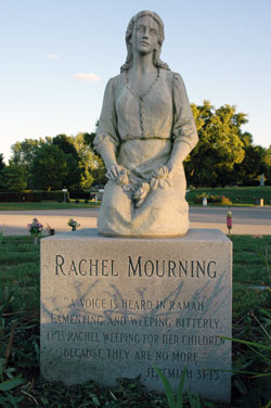 This statue of Rachel weeping for her children is located at the Infants Circle at Calvary Cemetery in Indianapolis. Many cemeteries offer special burial places for babies. The statue was inspired by the Scripture passage from Jeremiah 31:15, which reads, in part, “Rachel mourns her children, she refuses to be consoled because her children are no more.”