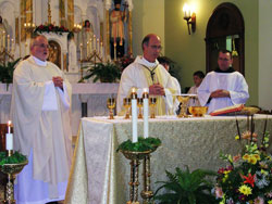 Benedictine Archabbot Justin Duvall of Saint Meinrad Archabbey, center, was the principal celebrant at the 160th anniversary Mass for St. Pius V Parish in Troy on Oct. 7. Concelebrating was Benedictine Father Barnabas Gillespie, pastor of St. Pius and a monk of Saint Meinrad. 