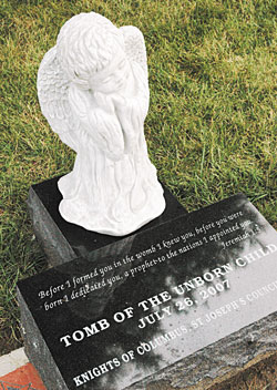 This memorial for babies who have died is located near the south drive of Our Lady of Peace Cemetery at 9001 N. Haverstick Road in Indianapolis. The St. Joseph’s Council of the Knights of Columbus in Indianapolis raised funds for the memorial on cemetery land donated by the Archdiocese of Indianapolis. The Scripture passage from the Book of Jeremiah reads, “Before I formed you in the womb I knew you, before you were born I dedicated you, a prophet to the nations I appointed you” (Jer 1:5).