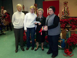 Franciscan Sister Shirley Gerth, third from left, parish life coordinator of St. Anne Parish in New Castle and St. Rose Parish in Knightstown, accepts a check for $16,488 for the St. Anne Building Fund on Jan. 6, the feast of the Epiphany of the Lord, from St. Anne parishioner Doris Addington-Brooks of New Castle, left, and St. Michael parishioners Connie Smith, second from left, and Lori Mayfield, right, of Greenfield. St. Michael Parish gave half of the proceeds from their annual fundraiser on Nov. 3 to help rebuild St. Anne Church, which was destroyed last year in an arson fire on Holy Saturday, April 7. (Submitted photo) 