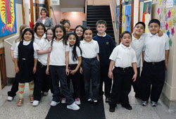 St. Philip Neri School students pose for an informal class picture on their way to lunch on Jan. 10 at the Indianapolis East Deanery grade school. Campus minister Mary McCoy stands in the hallway behind them. This year, 93 percent of St. Philip Neri’s students are Hispanic. Five years ago, that figure was about 70 percent. English as a New Language programs and bilingual teachers are helping tino students and their families acclimate to a new language and culture. (Photo by Mary Ann Wyand) 
