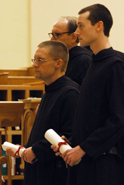 From left, Benedictine Brothers Francis Wagner and Karl Cothern hold their vow charts as they profess temporary vows as monks of Saint Meinrad Archabbey on Jan. 20 at the monastery’s church in St. Meinrad. (Submitted photo) 