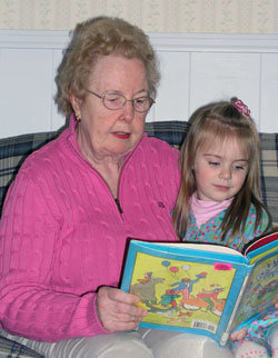 A mother of eight grown children, Carolyn Mueller was recently honored by Indianapolis television station WFYI as a 2008 Child Care Provider of the Year for the care and love she has given to her “second family” of children for the past 34 years. A member of Christ the King Parish in Indianapolis, Mueller reads a book to 3-year-old Maggie Smith. (Photo by John Shaughnessy) 