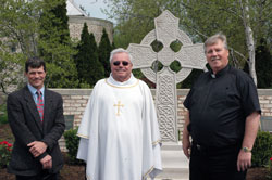 Stonecutter Matthew Bruce of Bedford, left, poses for a photograph with Father Charles Chesebrough, center, and Father Bernard Cox on April 27 outside Mary, Queen of Peace Church in Danville. Bruce works for Architectural Stone Sales in Bedford. Both Father Chesebrough and Father Cox have served as pastor of St. Vincent de Paul Parish in Bedford and Mary, Queen of Peace Parish in Danville. (Photo by Mary Ann Wyand)