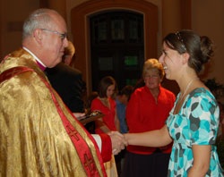 St. Roch parishioner Jennifer Fowler of Indianapolis accepts a Spirit of Youth Award from Msgr. Joseph F. Schaedel, vicar general, during the Catholic Youth Organization awards ceremony on May 8 at SS. Peter and Paul Cathedral in Indianapolis. (Submitted photo/courtesy CYO)
