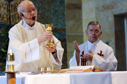 Father Herman Lutz, left, celebrates Mass with Father Henry Brown in the chapel at St. Paul Hermitage in Beech Grove on May 11, 2006. He serves as the chaplain at the Hermitage and lives in the priests’ wing of the retirement home operated by the Sisters of St. Benedict of Our Lady of Grace Monastery. (File photo by Sean Gallagher) 