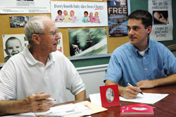 New Right to Life of Indianapolis president Marc Tuttle, right, talks with longtime pro-life volunteer John Hanagan, a member of St. Luke the Evangelist Parish in Indianapolis, during a recent meeting about the upcoming “Celebrate Life” dinner on Sept. 16 at the Indiana Convention Center in Indianapolis. (Photo by Mary Ann Wyand) 
