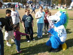 Two-year-old Tannon Rogers plays catch with Blue, the mascot for the Indianapolis Colts, at the Rittertown Fall Festival on Nov. 1. Sponsors of the event included Cargill Inc., Clarian, ClearChannel Outdoor, Coca-Cola, Dawson’s on Main, Diversified Business Systems, the Indianaplis Colts, The Indianapolis Star, Promotions Resources and Target. (Photo by Mike Krokos) 