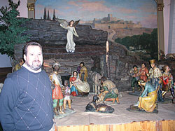 For Phil Schouten, the recently restored Nativity scene at SS. Peter and Paul Cathedral in Indianapolis brings back fond memories of his father, John, an immigrant who came to the United States through the help of the Church, an immigrant who volunteered to set up the crèche each Christmas as a way of giving thanks for the Church’s help to his family. (Photo by John Shaughnessy) 