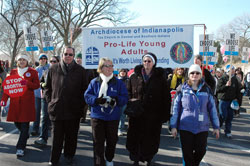 Archbishop Daniel M. Buechlein walks in the 36th annual March for Life on Jan. 22 in Washington, D.C., with Mary Schaffner, program coordinator of young adult ministry for the archdiocesan Office of Catholic Education; Servants of the Gospel of Life Sister Diane Carollo, director of the archdiocesan Office for Pro-Life Ministry; and St. Malachy parishioner Donna Johnson of Brownsburg. (Photo by Mary Ann Wyand) 