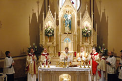 Father Jonathan Meyer, administrator of St. Joseph and St. Anne parishes in Jennings County, celebrates Mass on March 19, the feast of St. Joseph, in the newly restored St. Joseph Church. Concelebrants are, from left, Father Paul Etienne, pastor of St. John the Evangelist Parish in Indianapolis; Father Michael Fritsch, pastor of St. John the Apostle Parish in Bloomington; Father James Meade, pastor of St. Patrick Parish in Chesterton, Ind., in the Gary Diocese, and Father Joseph Sheets, a retired diocesan priest. Deacon John Hollowell, standing to the right of Father Meyer, assisted with the liturgy. (Photo by Mary Ann Wyand) 