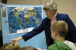 Providence Sister Mary Montgomery, the director of the Terre Haute Deanery Pastoral Center, talks with several religious education students about their global water quality project for the Catholic Social Teaching Fair on March 22 at St. Benedict Parish in Terre Haute. Many religious education programs at parishes in the Terre Haute Deanery sponsored the educational social justice programs for the first time. (Photo by Mary Ann Wyand) 
