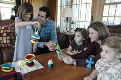 Steve and Joni Abdalla, second and fourth from left, play with their daughters, from left, Emma, Ruth and Vivian in their home in Indianapolis on April 1. The family is playing with the “My Mass Kit,” the first toy of the Abdalla’s Catholic toy company, Wee Believers. The Abadallas are members of Our Lady of the Most Holy Rosary Parish in Indianapolis. (Photo by Sean Gallagher)
