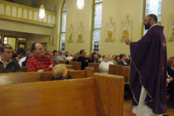 Father Todd Goodson, pastor of St. Ambrose Parish in Seymour and Our Lady of Providence Parish in Brownstown, preaches during a Sunday Advent Mass on Dec. 2, 2007, at St. Ambrose Church in Seymour. Annunciation Parish in Brazil and St. Simon the Apostle Parish in Indianapolis have launched formal evangelization efforts that have recently focused on inviting inactive Catholics and others outside their parishes to Mass. (File photo by Sean Gallagher) 