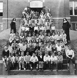 Students at the former St. Michael School in Cannelton in the 1935-36 academic year pose in front of the parish school with Benedictine sisters from Monastery Immaculate Conception in Ferdinand, Ind., who taught there. (Archive photo) 