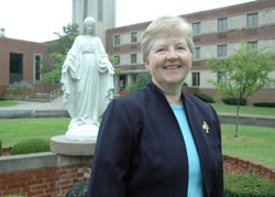 Benedictine Sister Juliann Babcock stands in front of Our Lady of Grace Monastery in Beech Grove on July 9. She was elected the new prioress of the monastic community on March 7, and was installed and began her six-year term of office on June 7. (Photo by Sean Gallagher) 