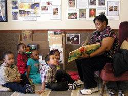 Educator Pat Hughes reads to 3-, 4- and 5-year-old children at St. Mary’s Child Center in Indianapolis, which is affiliated with the archdiocesan Secretariat for Catholic Education and Faith Formation. The center offers an early childhood education that its staff believes can improve the lives of at-risk children. (Photo by John Shaughnessy)