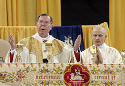 Archbishop Daniel M. Buechlein celebrates a special Mass marking the 175th anniversary of the Archdiocese of Indianapolis on May 3 at Lucas Oil Stadium in Indianapolis. At right is then-transitional Deacon John Hollowell. The special Mass drew a crowd of nearly 25,000 Catholics of all ages from central and southern Indiana. (File photo by Mary Ann Wyand)